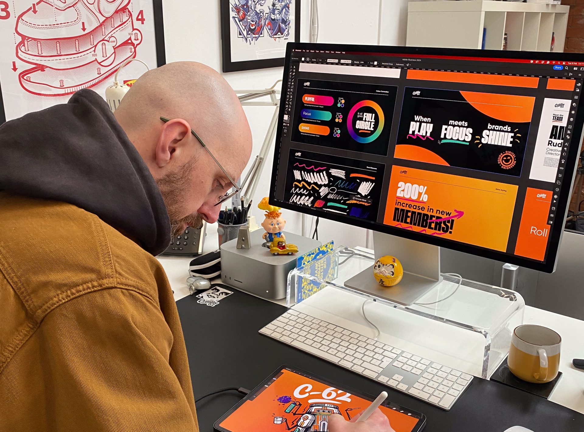 Adam, a designer, drawing on his iPad in front of his Mac compute