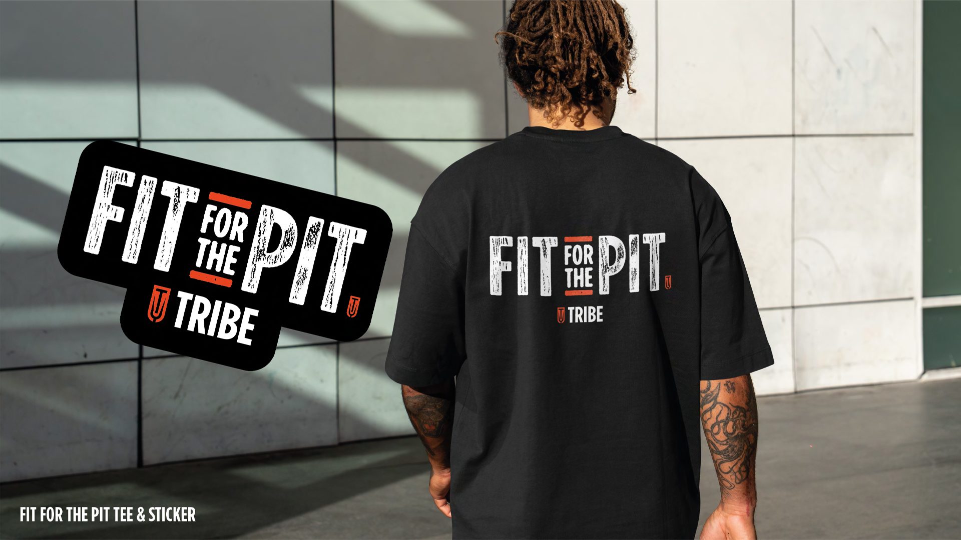 High-quality image of a black t-shirt with a large “Fit for the Pit” graphic on the back.