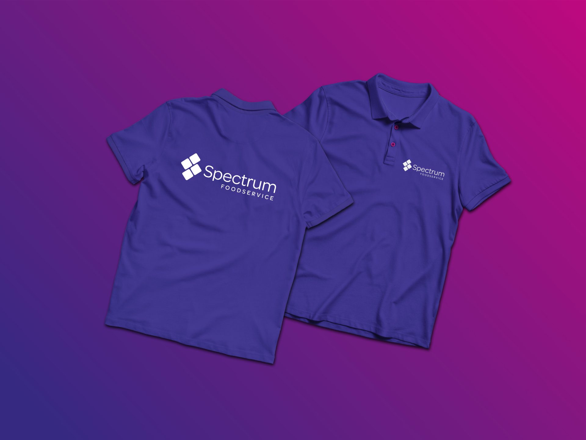 Two purple Spectrum polo shirts; one displays the front logo, the other shows the back print.