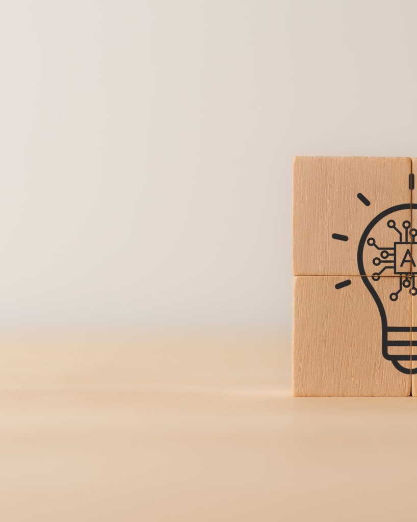 Four stacked blocks forming a square with a lightbulb illustration and “AI” in the center