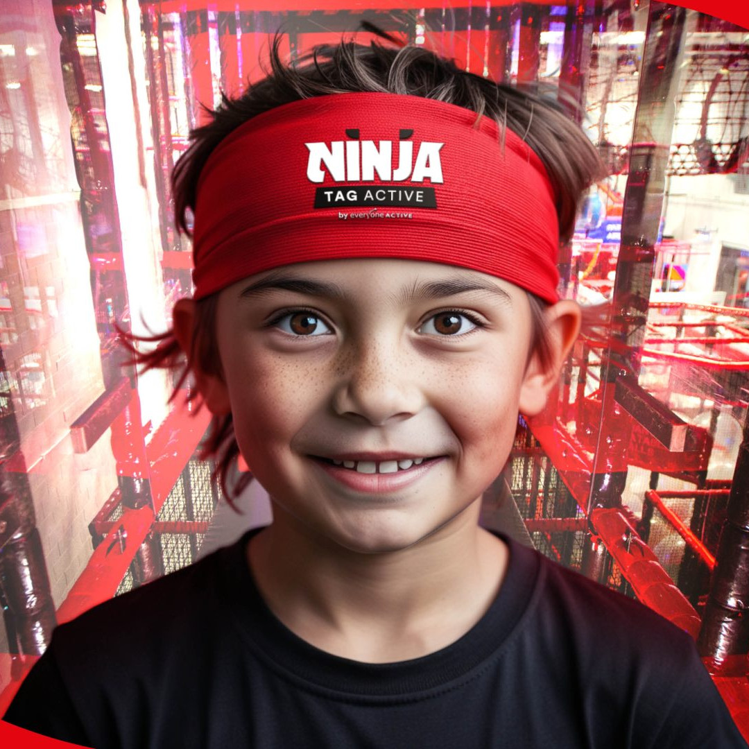 Young boy wearing a red Ninja Active Tag headband standing in front of the Ninja Active Tag course.