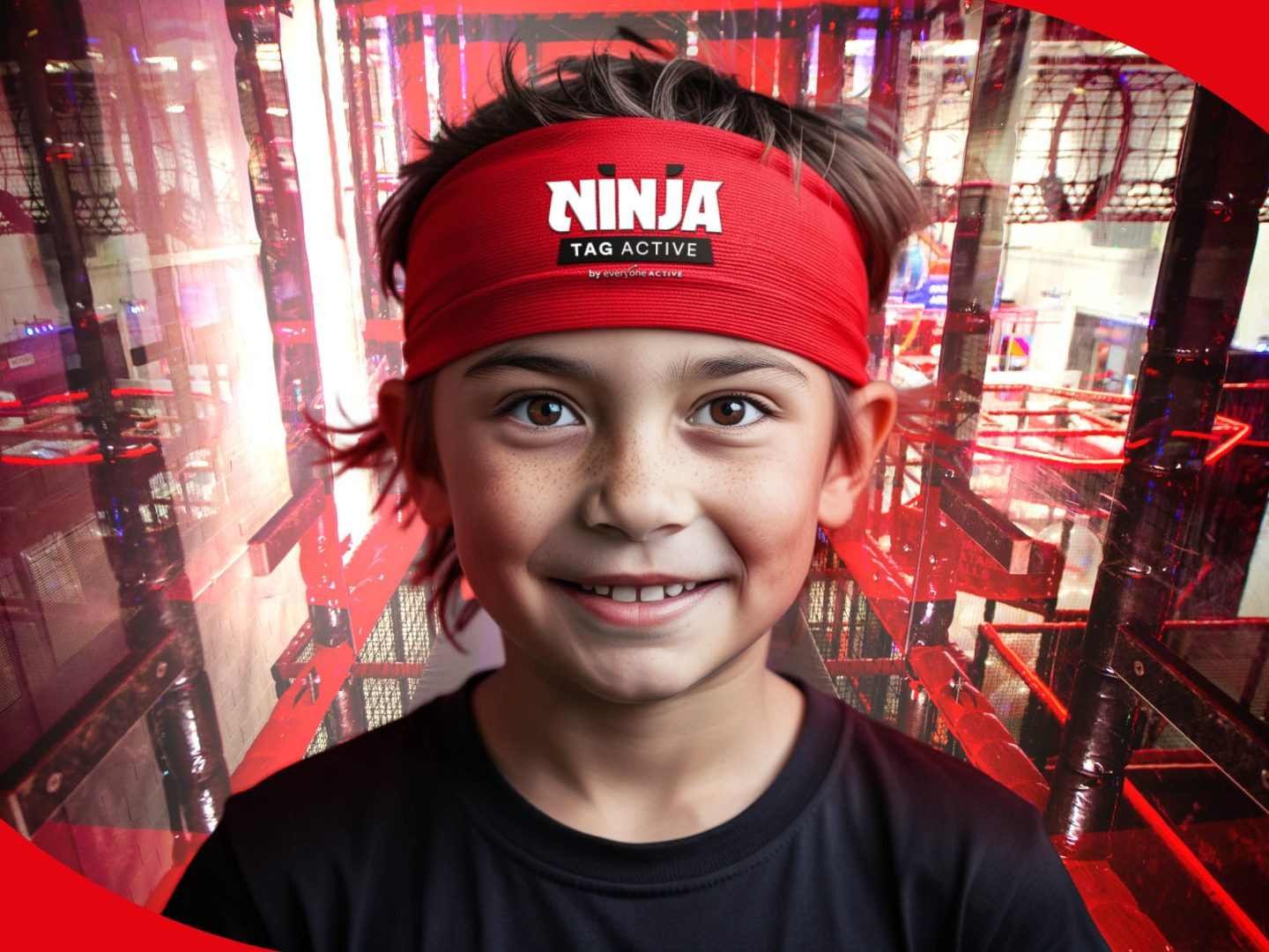 Young boy wearing a red Ninja Active Tag headband standing in front of the Ninja Active Tag course.