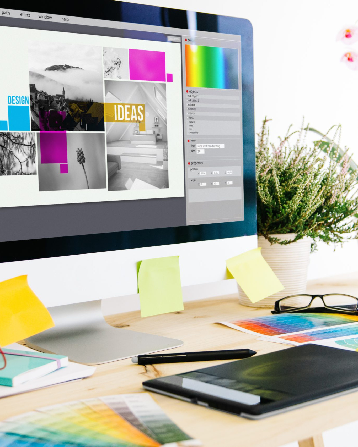 Graphic design workspace with branding concepts, colour palettes and digital design software on a desktop computer.
