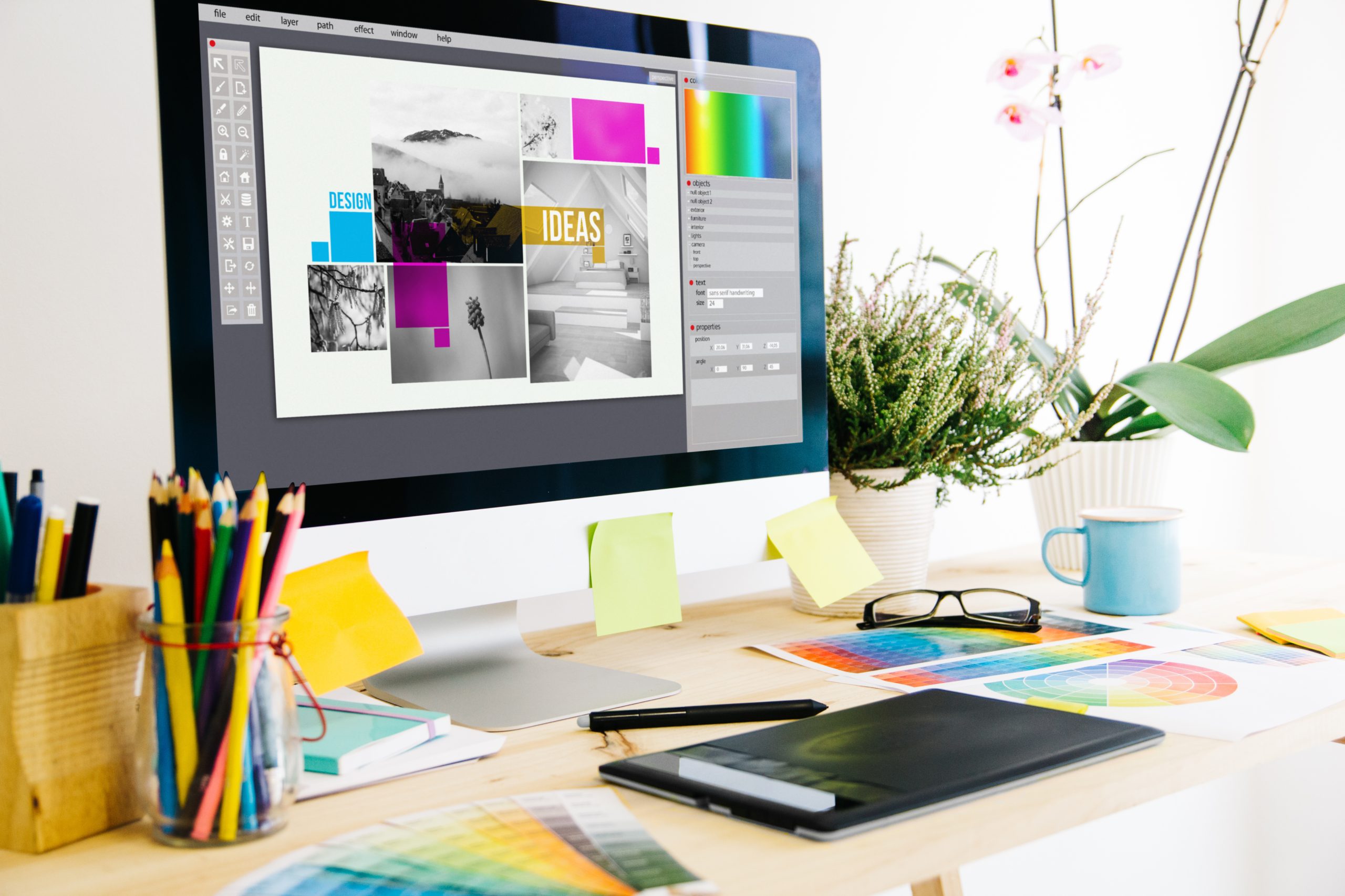 Graphic design workspace with branding concepts, colour palettes and digital design software on a desktop computer.